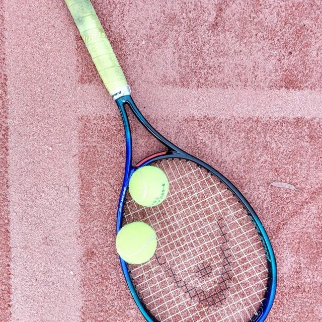 Racquet and balls on clay