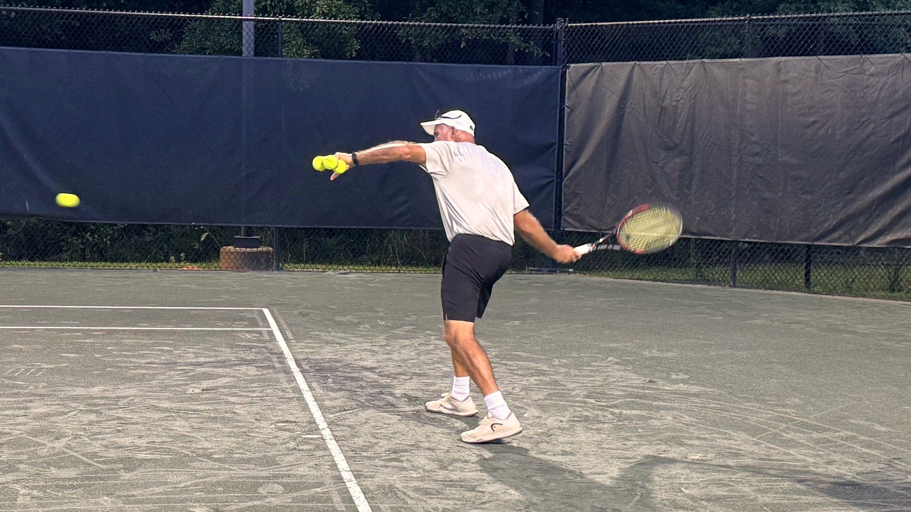 David Hume hitting a forehand on a clay court at the Yarbrough Tennis Center
