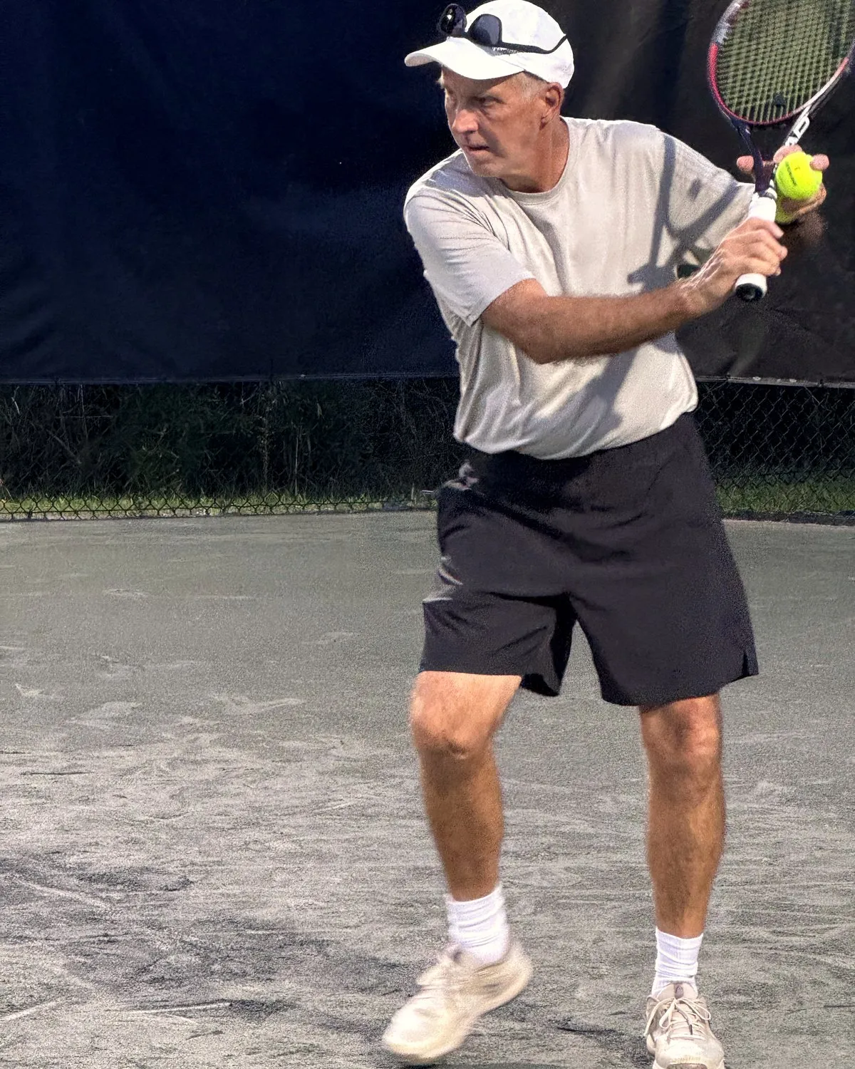David Hume preparing a backhand during a lesson